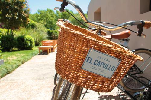 a bicycle with a basket with a sign on it at Posada El Capullo in Colonia del Sacramento