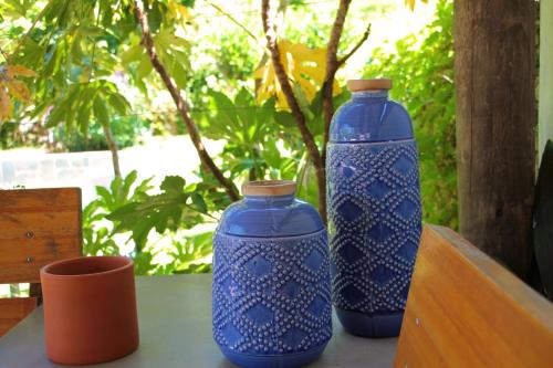 two blue vases sitting on top of a table at Posada El Capullo in Colonia del Sacramento