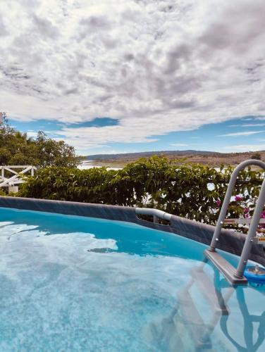 a swimming pool with a view of the ocean at RosePlace Valsequillo in Durazno