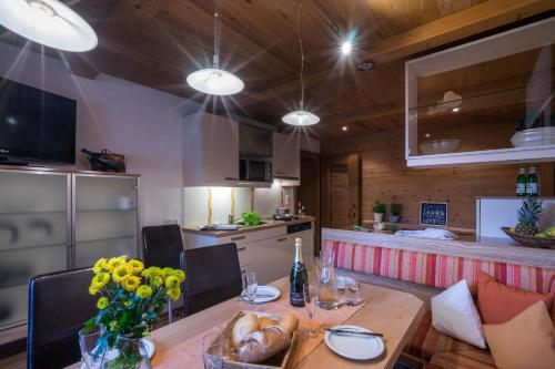 a dining room with a table and a kitchen at Aparthotel Gallahaus in Zell am Ziller