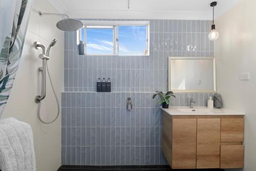 a bathroom with a sink and a shower at River Retreat in Dora Creek