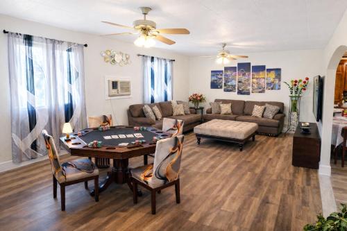 a living room with a table and a couch at Vacation Home 3.5 Mi to Strip/DT/Outlt up to 8 gst in Las Vegas