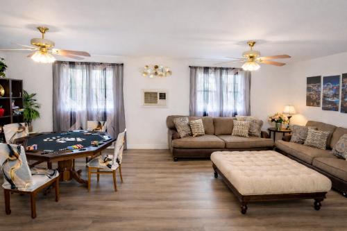 a living room with a couch and a table at Vacation Home 3.5 Mi to Strip/DT/Outlt up to 8 gst in Las Vegas