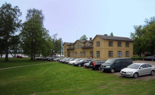 a row of cars parked in front of a building at Ediths Pensionat in Karlsborg