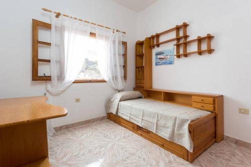 a bedroom with a bed and a window and a desk at Casa Candelaria in Alcalá