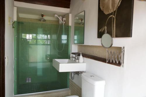 a bathroom with a shower and a sink and a mirror at Pousada Irradiante in Olinda
