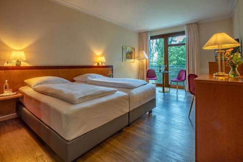 a bedroom with a large bed in a room at Dolce by Wyndham Bad Nauheim in Bad Nauheim