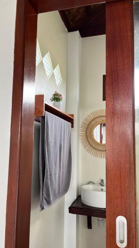 a bathroom with a sink and a mirror at Green Corner VILLA in Bukit Lawang