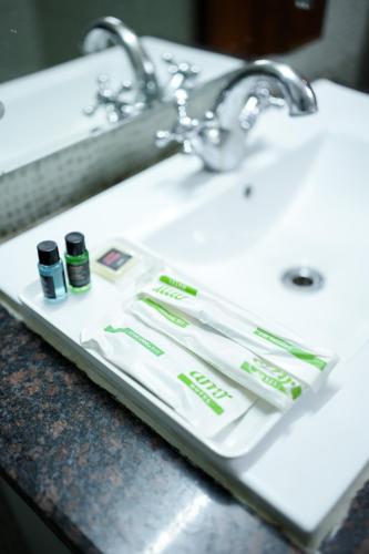 a bathroom sink with toothbrushes and toothpaste at The Altruist Katra Hotel in Katra