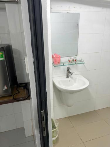 a bathroom with a sink and a mirror at LUCKY HOTEL LIEN PHUONG in Ho Chi Minh City