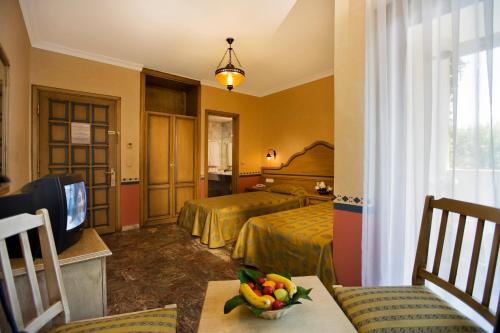 a hotel room with two beds and a television at Marvıda Hotel Akman Park in Kemer