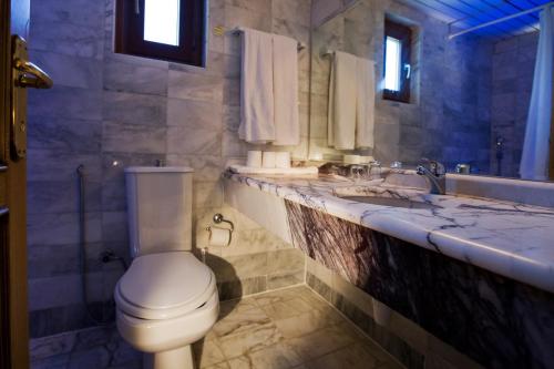 a bathroom with a toilet and a sink at Marvıda Hotel Akman Park in Kemer