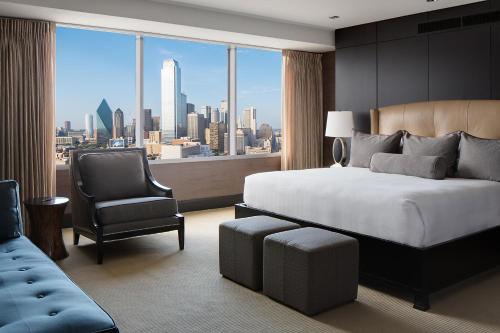 a bedroom with a bed and a chair and a window at Hyatt Regency Dallas in Dallas