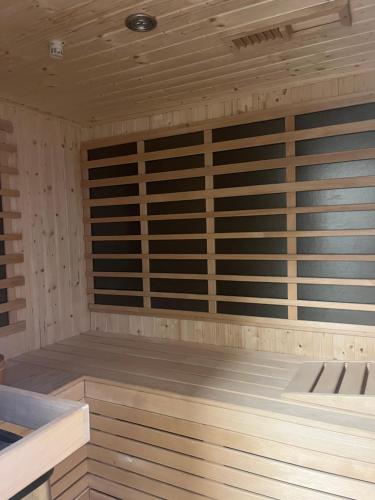a sauna with wooden walls and a wooden floor at The Valley Queens in Bovec