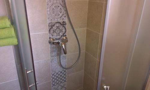 a shower with a shower head in a bathroom at Budanest Apartments in Budapest