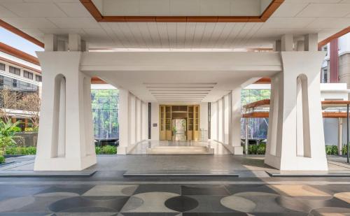 a view of the lobby of a building with columns at Hilton Bangkok Suvarnabhumi Golf Resort & Spa in Lat Krabang