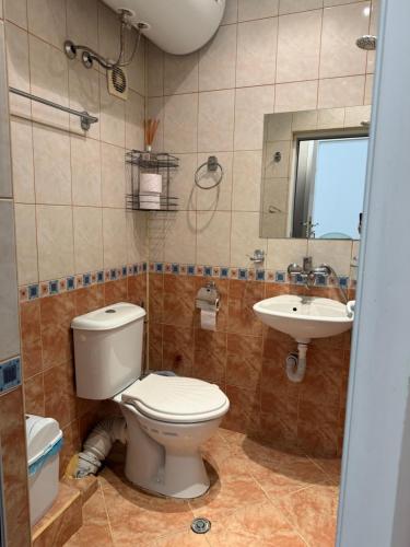 a bathroom with a toilet and a sink at Guest house “Poli” in Nesebar