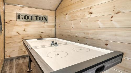 a kitchen with a stove in a wooden room at Jolene- Cabin Goals, Best Location, Pool & Hot Tub, Dogs! in Sevierville