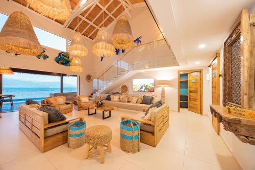 a living room with couches and chairs at Villa Tohora in Teavaro