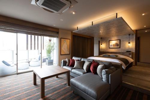 a hotel room with a bed and a couch at Y-HOTEL in Hiroshima
