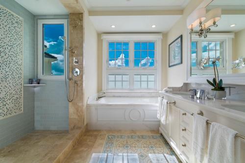 a bathroom with a tub and a sink and a shower at The Shore Club Turks & Caicos in Grace Bay