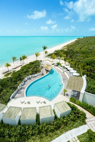 an aerial view of a resort with a swimming pool and the beach at The Shore Club Turks & Caicos in Grace Bay