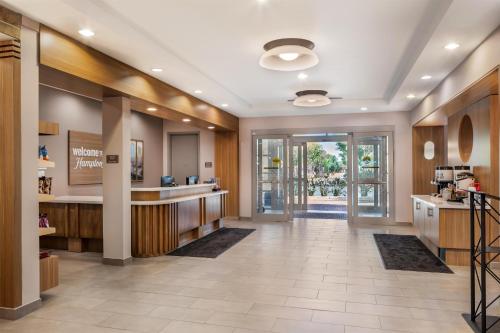 a hallway with a lobby with a reception counter and a lobby at Hampton Inn & Suites Riverside/Corona East in Riverside