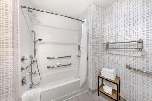a white bathroom with a shower and a tub at Hampton Inn & Suites Riverside/Corona East in Riverside
