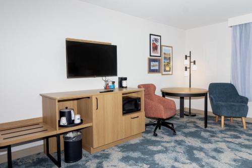 a hotel room with a television and a table and chairs at Hampton Inn Rock Springs in Rock Springs