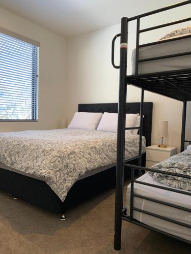 a bedroom with a bunk bed next to a window at Keystone in Dinner Plain