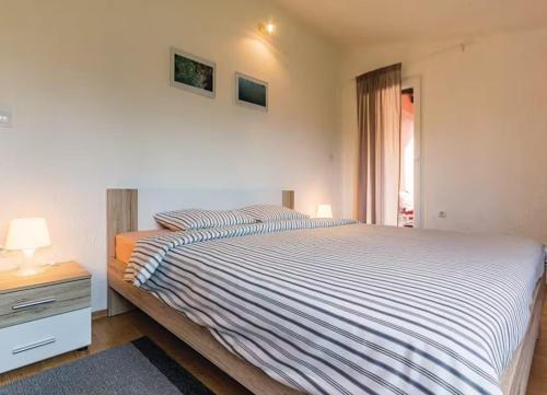a bedroom with a large bed and a window at Gorgeous Apartment Garma in Kavran