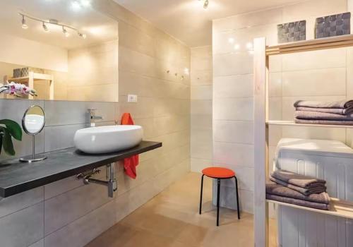 a bathroom with a sink and a mirror and towels at Gorgeous Apartment Garma in Kavran