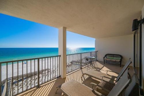 a balcony with chairs and a view of the beach at Wind Drift 604S condo in Orange Beach