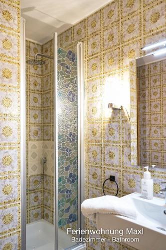a bathroom with a shower and a tub and a sink at Ferienwohnung Maxl in Schwangau
