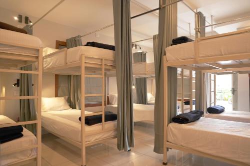 a room with three bunk beds in a room at Blue Vista Residency in Kalpetta
