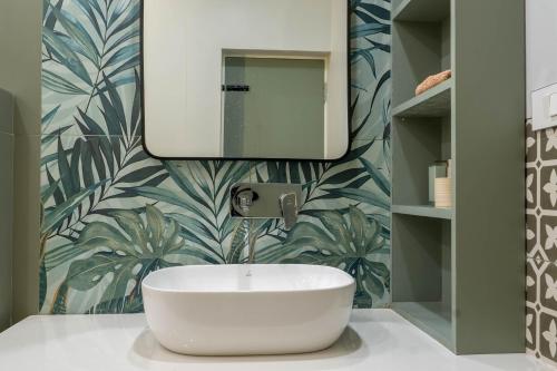 a bathroom with a white sink and a mirror at Villa Aura in Siliguri