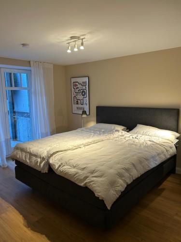 a large bed in a bedroom with a window at Seepferdchen in Timmendorfer Strand