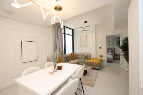 a white kitchen and living room with a couch at Premium 1BR on Al Maryah Island, near ADGM in Abu Dhabi