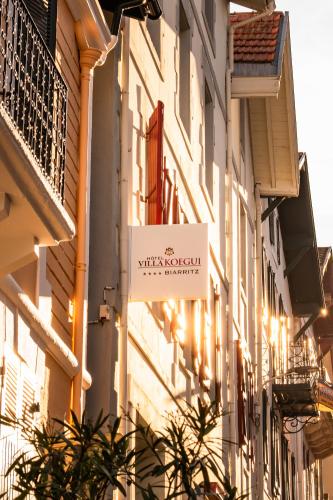 a building with a sign on the side of it at Hotel Villa Koegui Biarritz in Biarritz