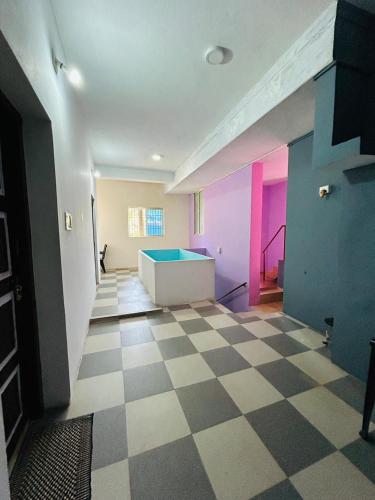 an empty room with a blue tub in the middle at Comforts Bhairavi INN in Kalyānpur