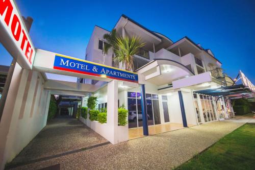 a motel and apartment building with a sign on it at Cosmopolitan Motel & Serviced Apartments in Rockhampton