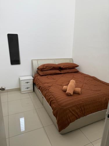 a bed with a stuffed animal on it in a bedroom at Teratak Shamar in Kampong Tebok Pulai