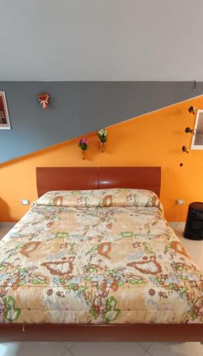 a bedroom with a bed with a wooden headboard at Chalet Nautilus in San Mango Piemonte