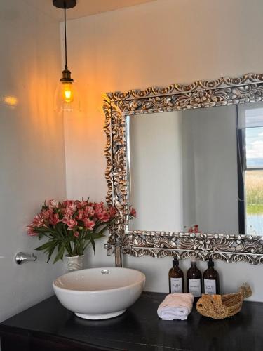 a bathroom with a sink and a mirror at Amalia Titicaca Lodge in Puno