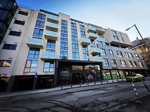 a large building with a car parked in front of it at Adella Boutique Hotel - Free Secured Parking in Sofia