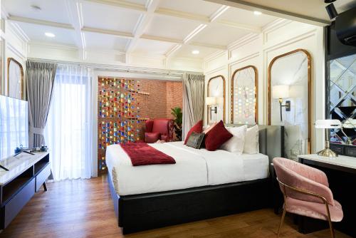 a bedroom with a large white bed and a sink at THE MOMENT, Chiang Mai in Chiang Mai