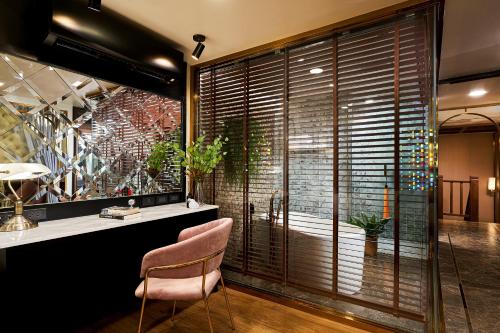 a room with a large window with a bath tub at THE MOMENT, Chiang Mai in Chiang Mai