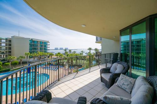 a balcony with a view of a swimming pool at Phoenix on the Bay 1309 in Orange Beach