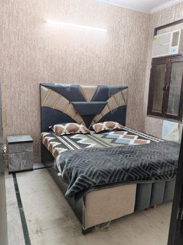 a bedroom with a bed with a blue bed frame at Hotel Blue Heaven in Karnal