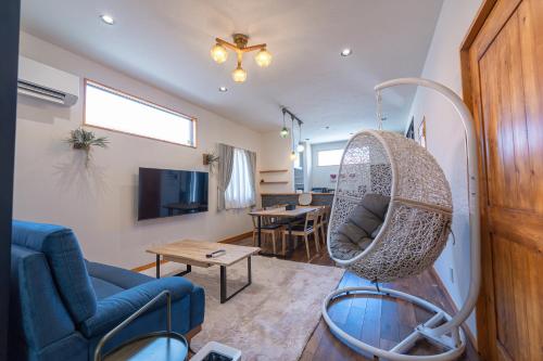 a living room with a chair and a table at Miyako Island Breeze in Miyako-jima